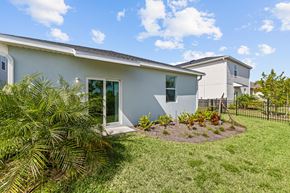 Babcock Ranch apartment for rent - A house with a white exterior and a green lawn.
