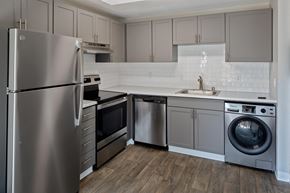 Vancouver apartment for rent - a kitchen with gray cabinets and stainless steel appliances