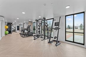 Caldwell apartment for rent - a gym with exercise equipment and large windows