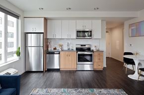 Portland apartment for rent - A modern kitchen with wooden cabinets and stainless steel appliances.