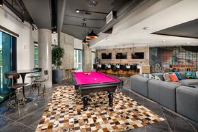 Los Angeles apartment for rent - A pool table is in the middle of a room with a checkered floor.