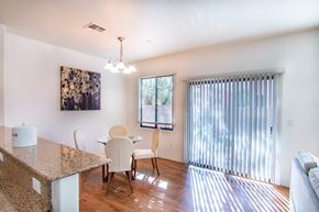 Sierra Vista apartment for rent - A kitchen with a granite counter top and a dining table with chairs.