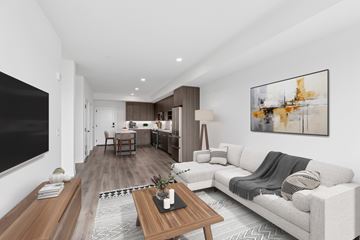 Seattle apartment for rent - A modern living room with a grey couch and a wooden coffee table.
