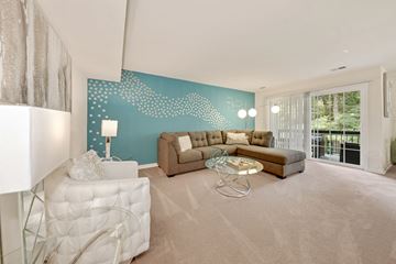 Columbia apartment for rent - A living room with a white sofa and a glass coffee table.