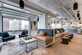 Seattle apartment for rent - A modern living room with a large window and a view of the city.