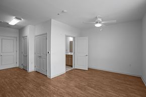 Arlington apartment for rent - A room with a ceiling fan and wooden flooring.