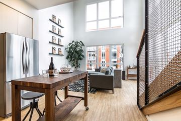 Portland apartment for rent - a living room with a table and a refrigerator