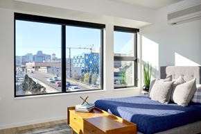 Portland apartment for rent - Bedroom with large windows and white walls at Grand Belmont Apartments in Central Eastside Portland, Oregon.