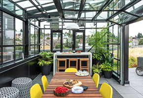 Seattle apartment for rent - A plant lovers dream! Showing a greenhouse with dining table and plants inside. Great space for entertaining.