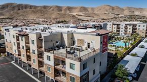 Las Vegas apartment for rent - Apartment complex with a pool and a mountain in the background.
