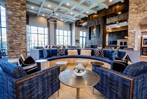 Las Vegas apartment for rent - A living room with a stone pillar and a blue couch.