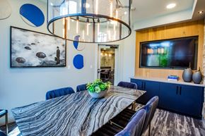 Las Vegas apartment for rent - A modern dining room with a large table and a television on the wall.