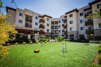 Game lawn hosting jumbo jenga, corn hole, frisbees and pickle ball