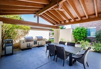 Covered outdoor patio and dining area with bbqs