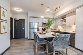 Tampa apartment for rent - a kitchen with a table and chairs and a refrigerator