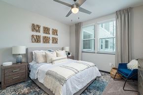 Tampa apartment for rent - a bedroom with a bed and a ceiling fan