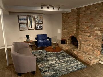 Holladay apartment for rent - a living room with a brick fireplace and a couch and chairs