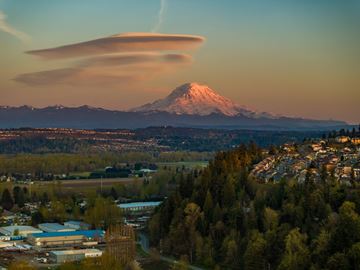 Puyallup apartment for rent - A mountain with a snow cap is in the background with a town in the foreground.