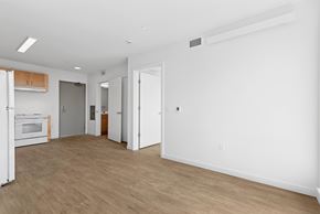 Seattle apartment for rent - A spacious room with a white wall and a wooden floor.