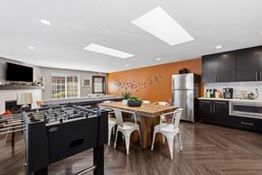 Everett apartment for rent - A modern kitchen with a foosball table in the middle.