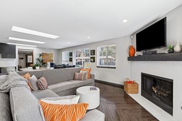 Everett apartment for rent - A modern living room with a grey couch and a fireplace.