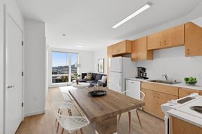 Seattle apartment for rent - A kitchen with a table and chairs in front of a window.