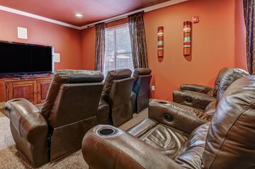 San Antonio apartment for rent - A living room with brown leather chairs and a television.