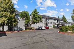 Spokane Valley apartment for rent - the view of a building with cars parked in front of it