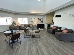 Tucson apartment for rent - A living room with a grey sofa, a black coffee table, and a brown chair.