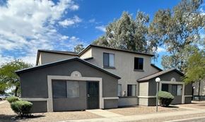 Tucson apartment for rent - A modern house with a grey exterior and a black gate.