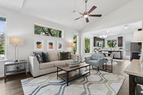 Austin apartment for rent - A living room with a white couch, a coffee table, and a ceiling fan.