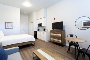 Walla Walla apartment for rent - a bedroom with a bed and a desk and a television