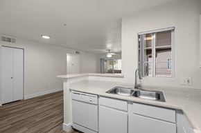 Flagstaff apartment for rent - A kitchen with white cabinets and a window.