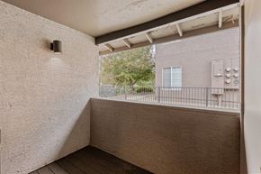 Flagstaff apartment for rent - A balcony with a railing and a building in the background.