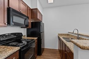 Richland apartment for rent - a kitchen with granite countertops and black appliances