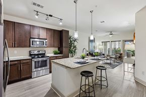 Celebration apartment for rent - A kitchen with a white counter top and a refrigerator.