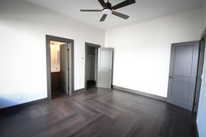 Tucson apartment for rent - A room with a ceiling fan and wooden flooring.