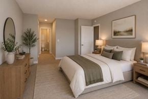 Richland apartment for rent - A well-lit bedroom with a large bed and a wooden dresser.