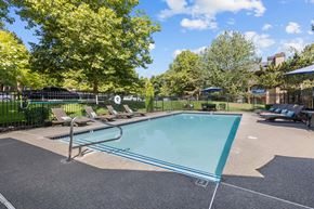 Federal Way apartment for rent - a swimming pool with lounge chairs and trees in a park