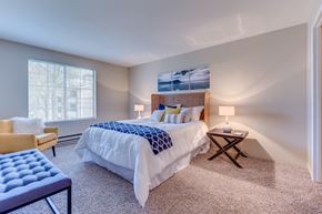Everett apartment for rent - A bedroom with a large bed and a chair.