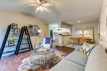 Everett apartment for rent - A modern living room with a grey sofa and a glass coffee table.