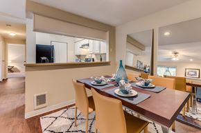 Everett apartment for rent - A dining room with a wooden table set for four.