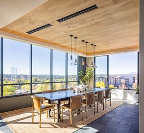 Bend apartment for rent - A dining room with a large table and chairs with a view of the city.