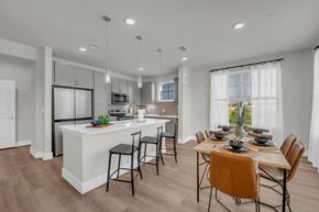Pflugerville apartment for rent - A modern kitchen with a dining table set for four.