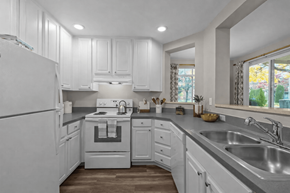Lynnwood apartment for rent - A white kitchen with a stove top oven and a refrigerator.