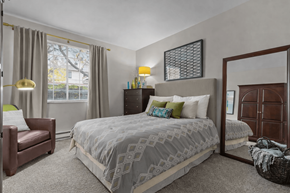 Lynnwood apartment for rent - A bedroom with a large bed and a chair.