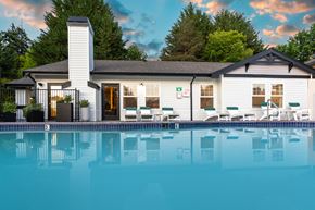 Port Orchard apartment for rent - a swimming pool in front of a white house with a pool