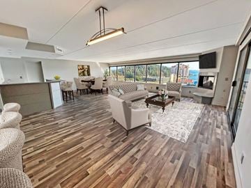 Coeur Dalene apartment for rent - A spacious living room with a large couch and a coffee table.