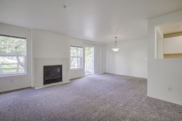 Issaquah apartment for rent - A living room with a fireplace and carpeted floor.