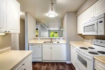 Issaquah apartment for rent - A kitchen with white cabinets and appliances.